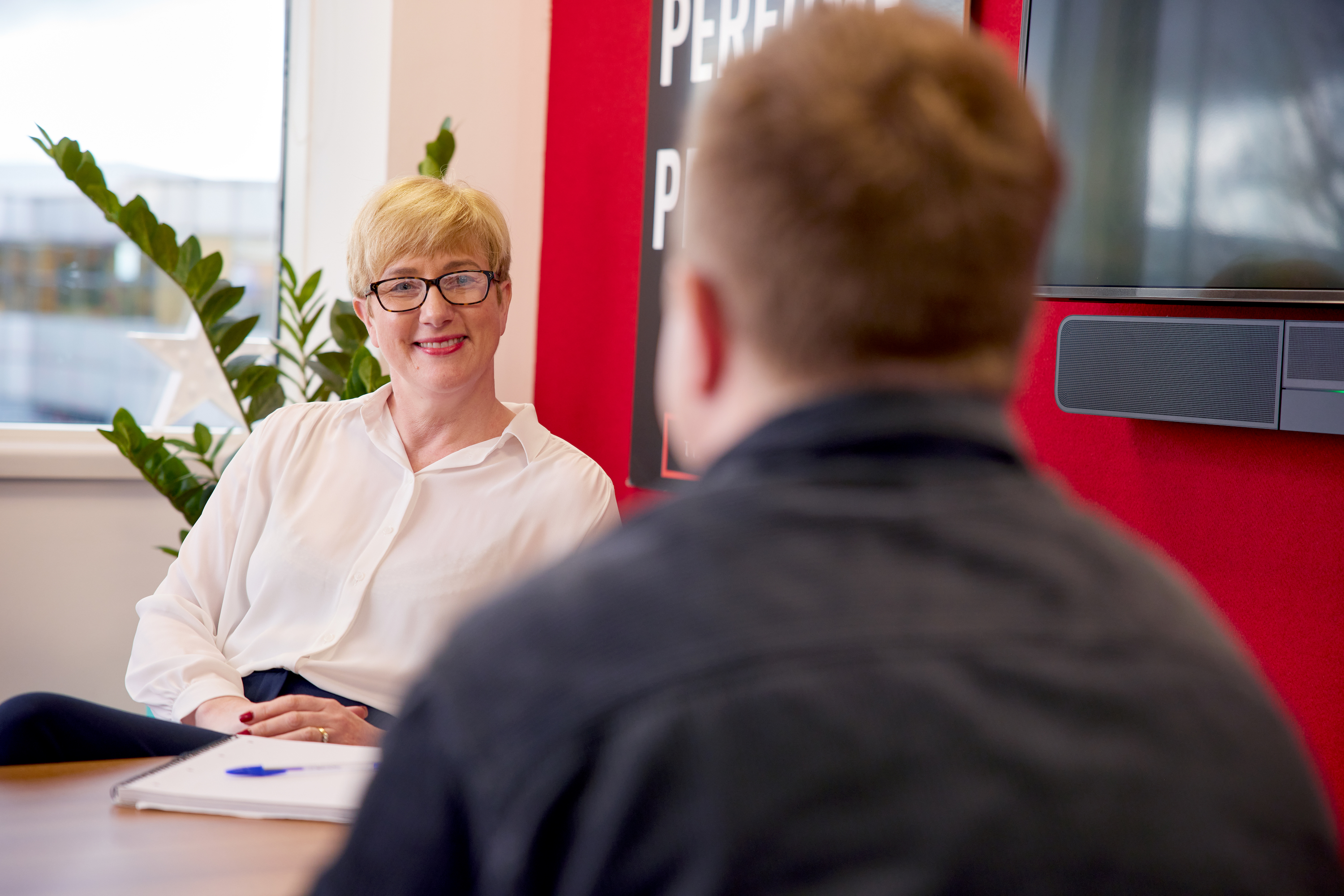 Woman interviewing, looking directly at a person out of view.