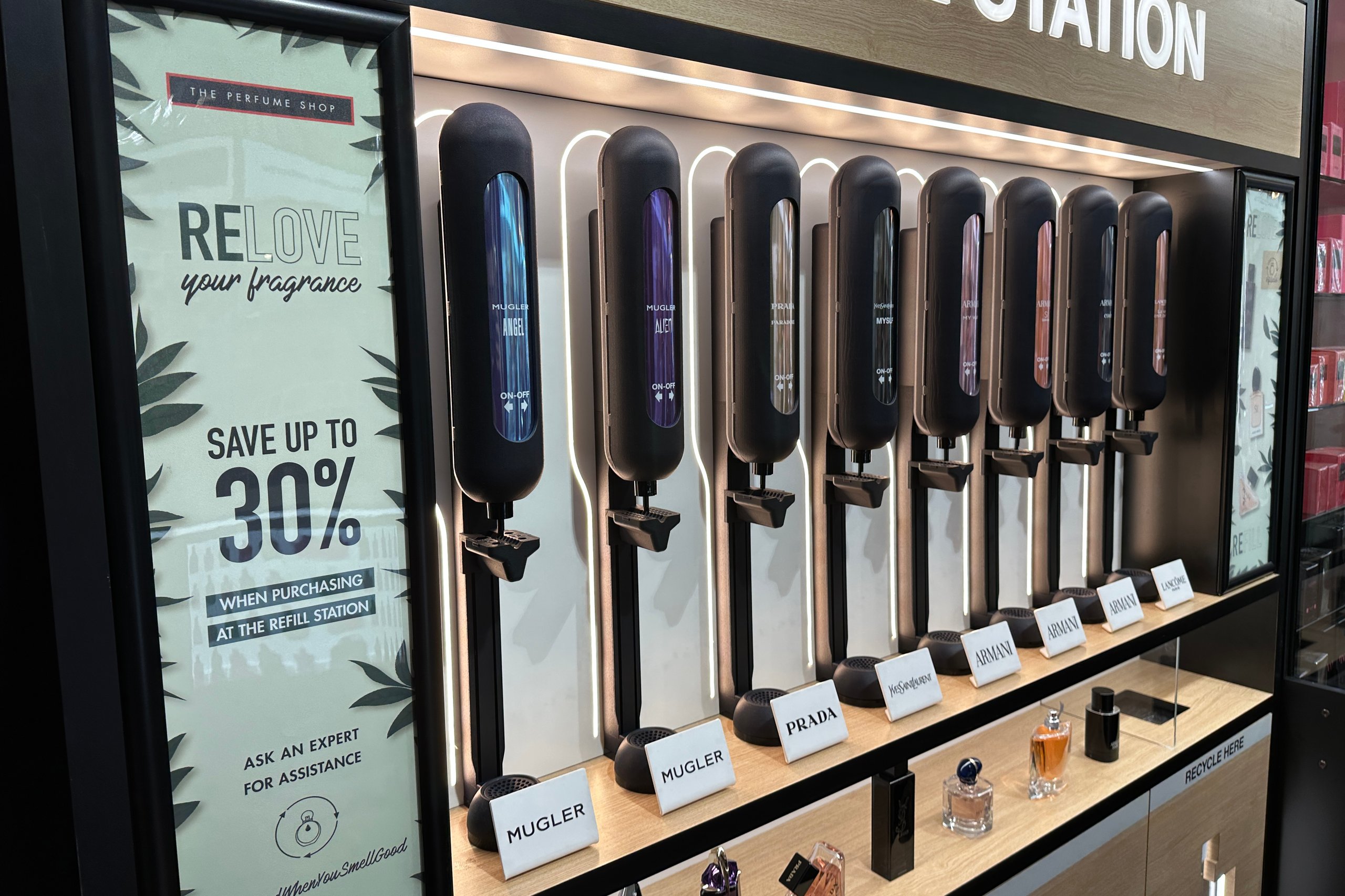 Refill station with perfumes from brands like Mugler, Prada, and Armani. "Relove your fragrance."