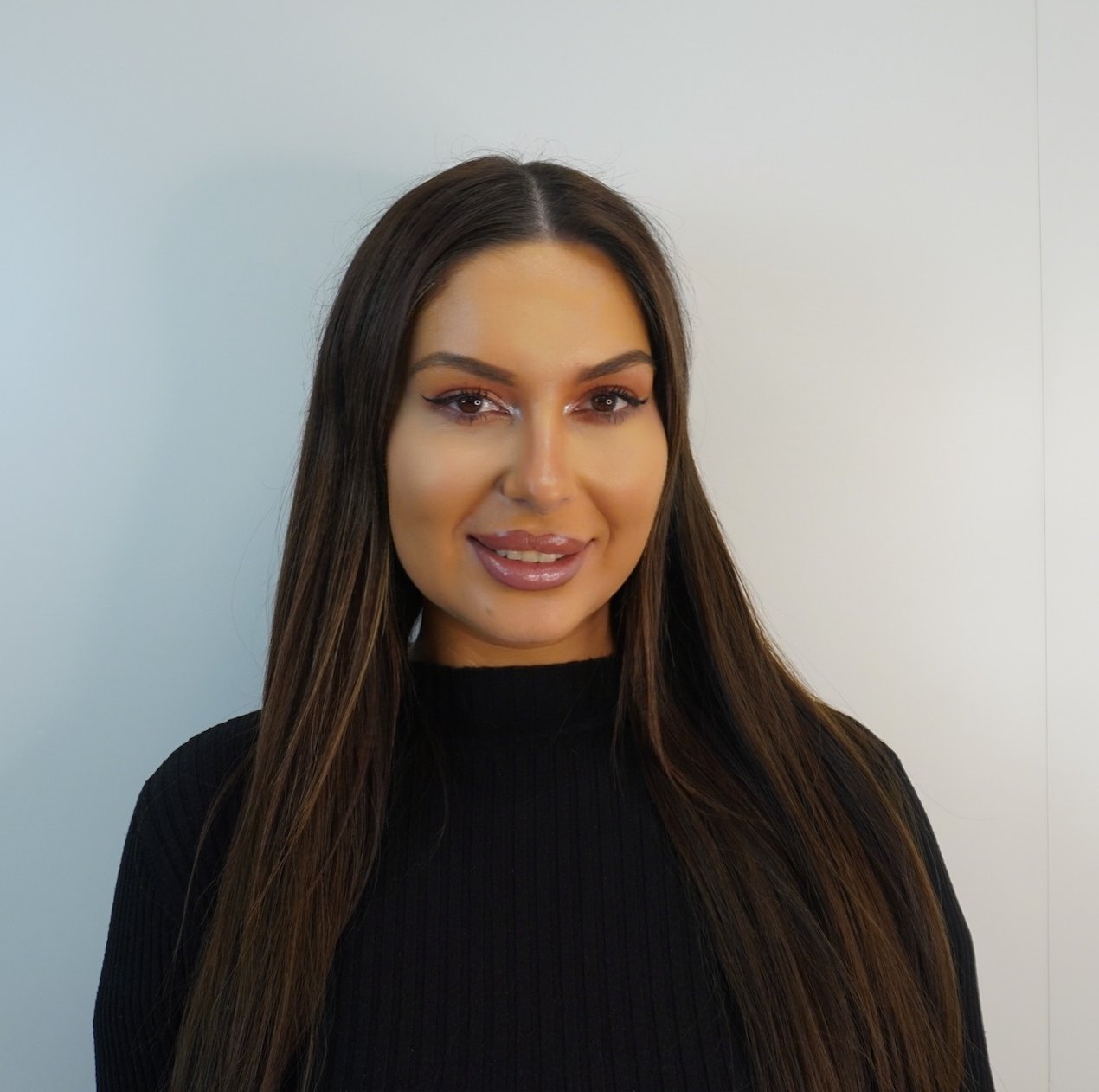 Portrait of a woman with long hair and makeup.